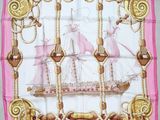 pink and gold square scarf with a sailing ship on it