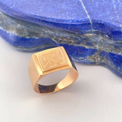 an image of a gold signet ring on a blue stone