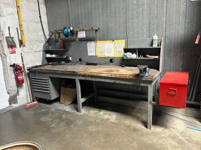 a workbench in a garage with a lot of tools on it