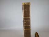 an old book sitting on a table next to a pair of shoes