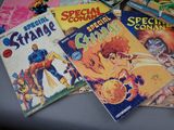a lot of comic books sitting on a table