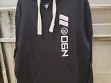 black hoodie with white logo on it hanging on a rack in a garage