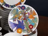 a lot of plates and cups on the table