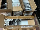 several boxes of assorted items are stacked on a pallet on the floor