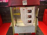 a popcorn machine sitting on a table in a restaurant