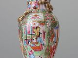 a vase that has a lid on it on a table