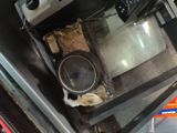 a dirty stove with a metal pan on top of it