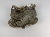 a silver plate that has a small animal on it