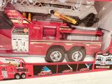 a toy fire truck with a ladder in the back of it