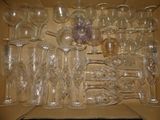 a lot of empty wine glasses in a box