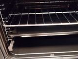 an open oven with the door open and a rack in the oven