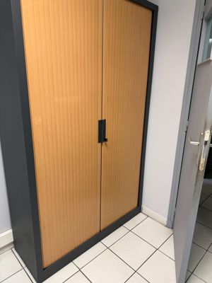 an image of a bathroom with a wooden cabinet and tiled floor