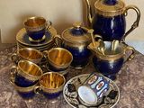a picture of a blue and gold tea set on a marble table