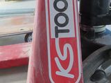 a close up of a red skateboard with a sticker on it