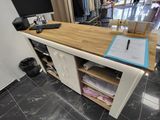 a desk with a computer on it in a clothing store