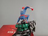 statue of spider - man on a motorcycle on display in a red box
