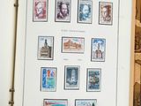 an open book with stamps on it sitting on a table