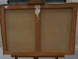 an old wooden easel with a piece of fabric on top of it