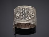 a silver bracelet with a cross on it