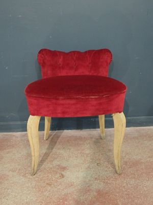 a red chair that is sitting on the floor