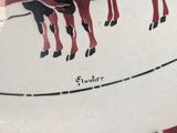 a red and black plate with a picture of a cow and a calf on it