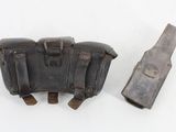 a pair of leather holsters and a knife on a white surface