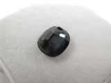 a black diamond on a white cushion