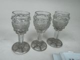 three wine glasses sitting next to each other on a table