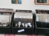 three cd ' s sitting on a table in front of a wall