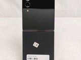 the back of a black cell phone sitting on top of a table