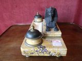 a statue of a sphinx and a bell on a table