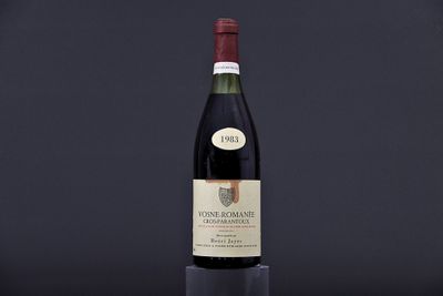 a bottle of wine sitting on top of a wooden table