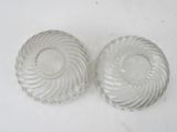 pair of clear glass knob covers with spiral design on them