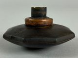 a small black object on a white surface