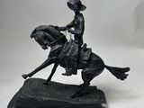 a statue of a man riding a horse with a hat on