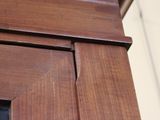 a close up of a wooden door with a glass window