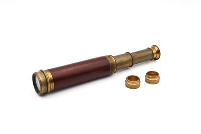 an old brass telescope with a wooden case and brass rings
