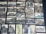 a lot of old black and white pictures on the table