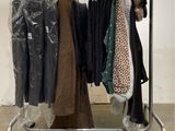 a rack of clothes that is on display in a room