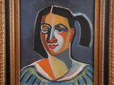 an oil painting of a woman with a ponytail in a gold frame