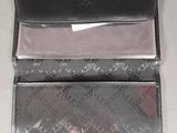 a black wallet with a red tag on it