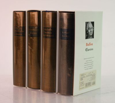 three books are stacked on top of each other on a table