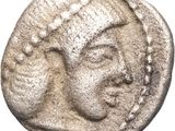a silver coin with a woman ' s face on it