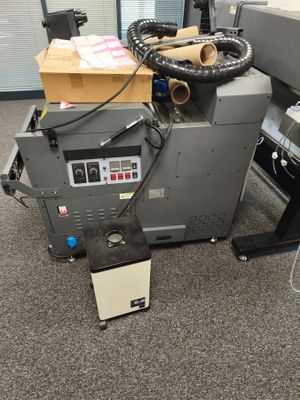 a machine that is sitting on the floor next to a box