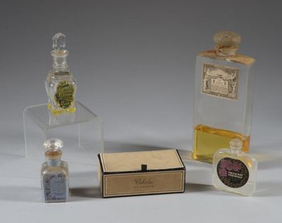 trois flacons de parfum posés l'un à côté de l'autre sur une table