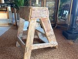 a wooden step stool in the middle of a living room
