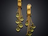 a pair of yellow gold earrings with green stones