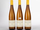 trois bouteilles de vin posées l'une à côté de l'autre sur une table