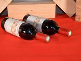 two bottles of wine sitting next to each other on a table