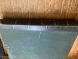 a small black piece of metal on the side of a wooden wall